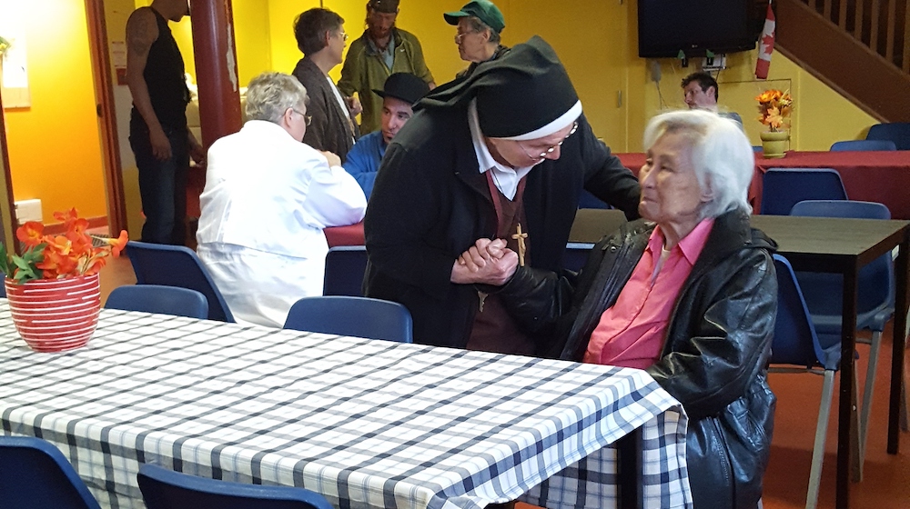 Felician sisters mingle with guests at St. Felix Centre, a Felician-sponsored shelter in Toronto, Ontario, before the coronavirus pandemic. (Courtesy of St. Felix Centre, Felician Sisters of North America/Elliott Cramer)