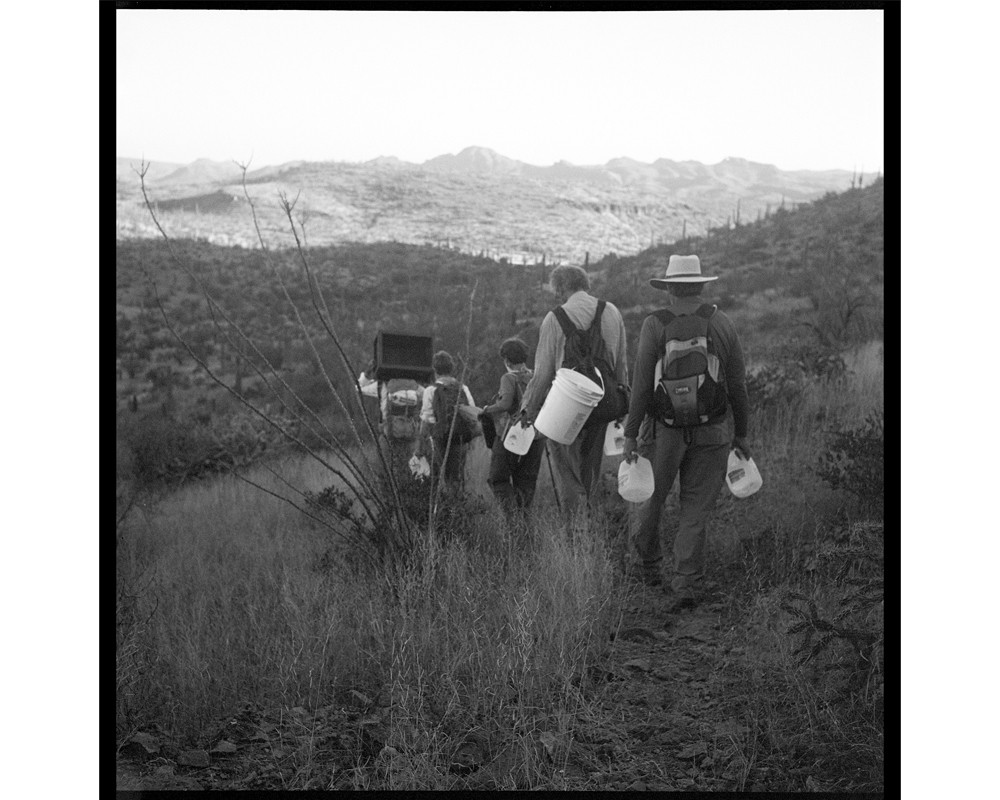 Each volunteer carries as much water, blankets, food and socks as they can. Some carried 4 or 5 gallons of water, a weight of about 30-40 pounds. (Lisa Elmaleh)