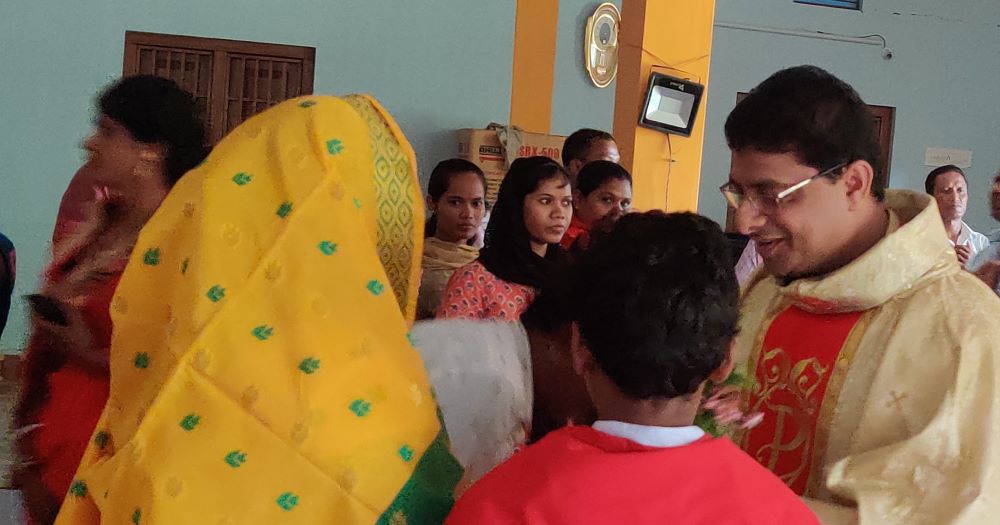 The faithful at Anugraha Peetha (The Center of Grace) greet Fr. Martin Chintamani after  daily Mass on his priesthood ordination anniversary on June 5. (Sujata Jena)