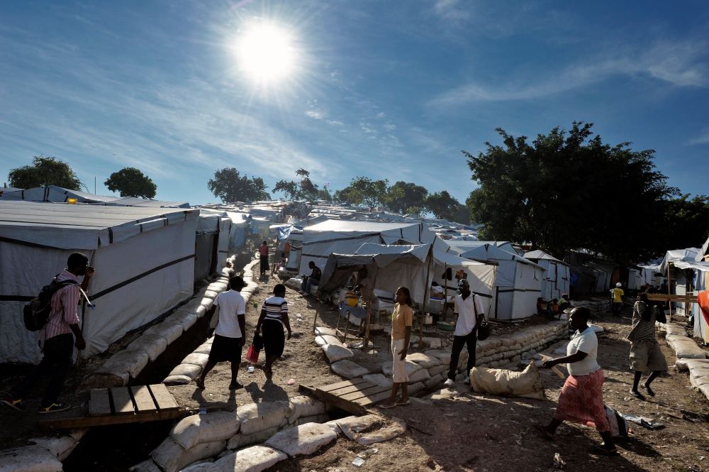 People go about their daily activities in a tent city of Haitian earthquake survivors on a former nine-hole golf course in Port-au-Prince, Haiti, Oct. 22, 2010. The Petionville Club hosted more than 44,000 people left homeless after the Jan. 12, 2010, ear