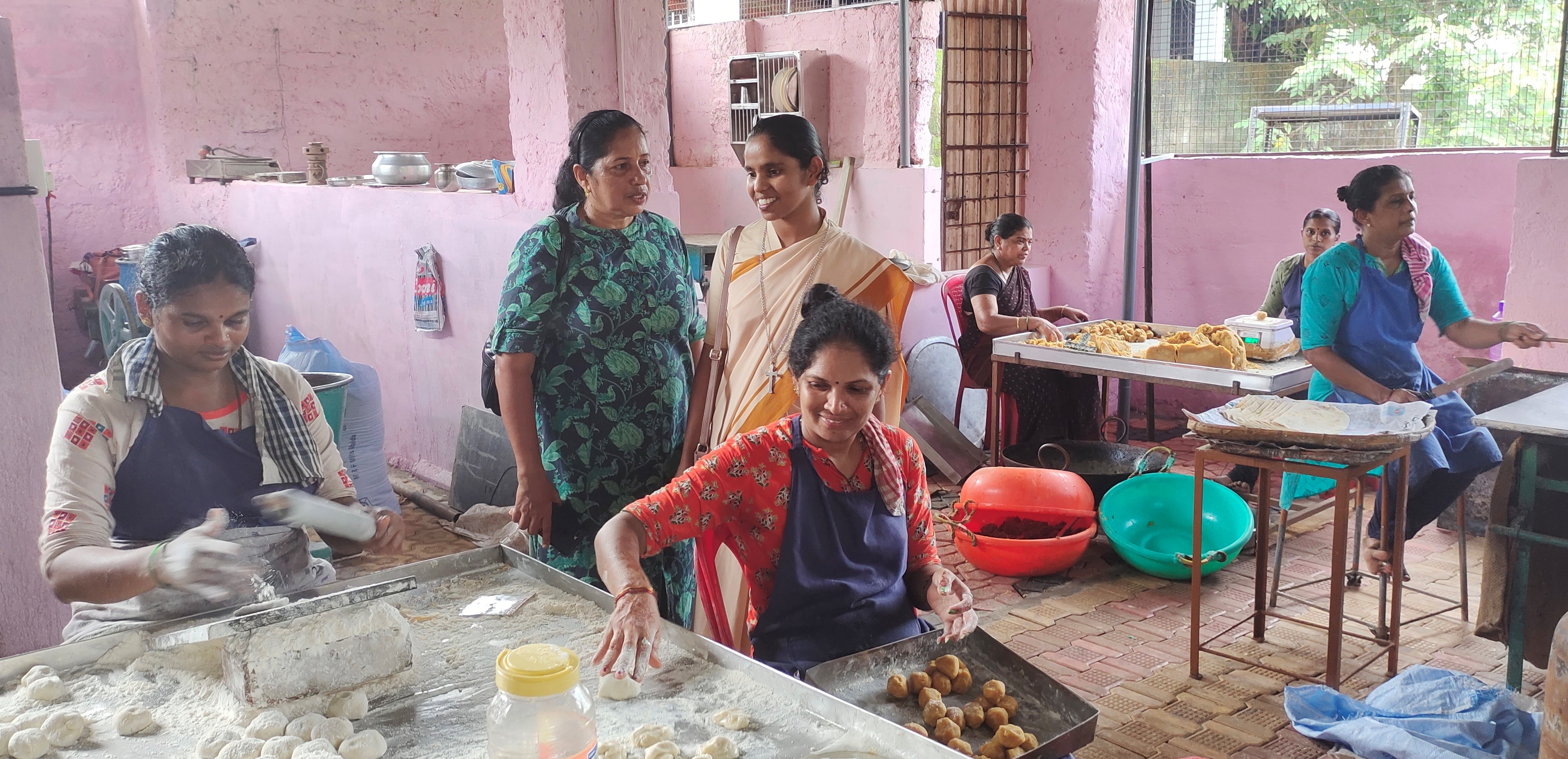 Lavisha D'Souza, Lavina D'Cunha and food factory staff: Bethany Sr. Lavisha D'Souza, third from left, with entrepreneur Lavina D'Cunha, second from left, with the staff on duty at D'Cunha's food factory in Mangaluru, southern India. (Thomas Scaria)