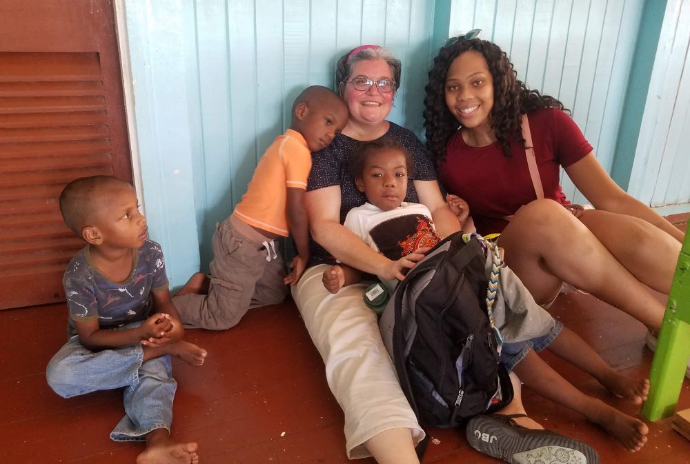 Mercy Sr. Jennifer Wilson, center, with Mount Mercy Academy student Anani Debose, right, on a service trip to Guyana in 2019 (Courtesy of Jennifer Wilson)