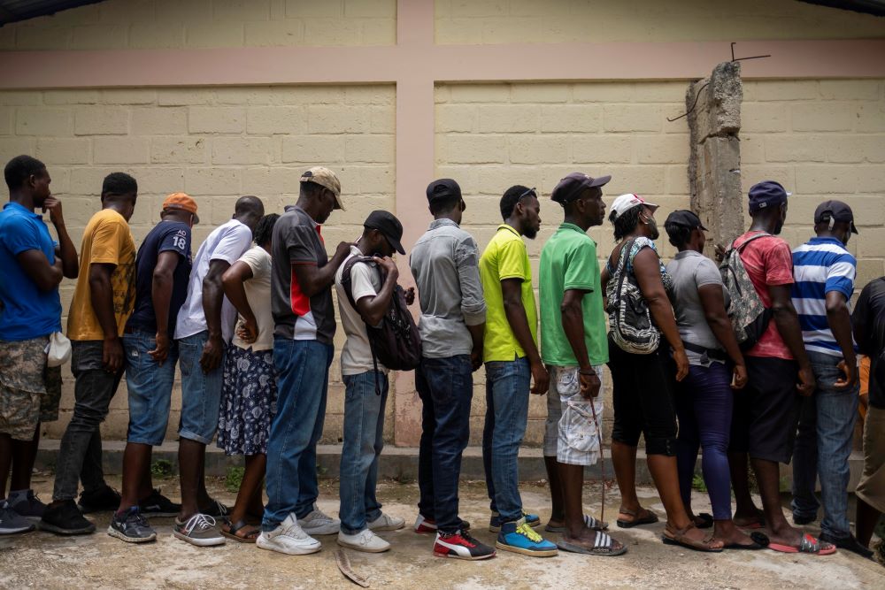 People affected by an earthquake wait for food provided by the World Food Program on Aug. 24, 2021, at a school in Port Salut, Haiti. (CNS/Reuters/Ricardo Arduengo)