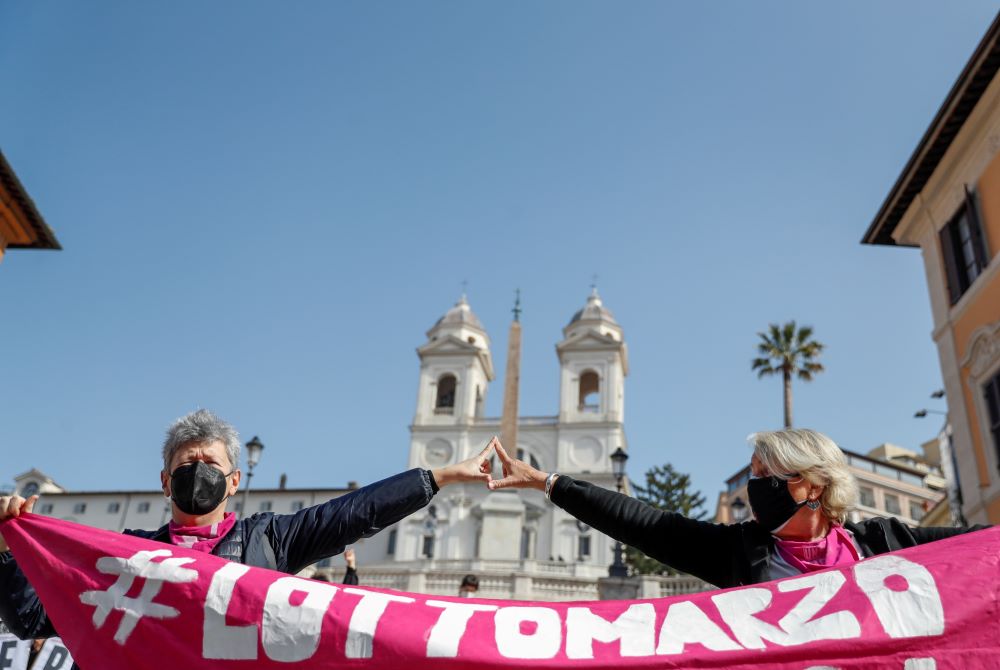 Activists protest at Rome's Spanish Steps in February, calling for an end to violence against women and more government aid for those struggling because of the pandemic. (CNS/Reuters/Yara Nardi)
