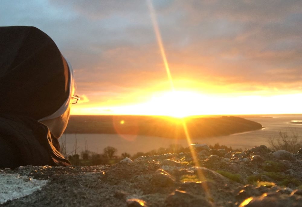 The author looks at the sunrise over Ireland's County Wexford and the River Barrow in January 2022. (Kathryn Press)