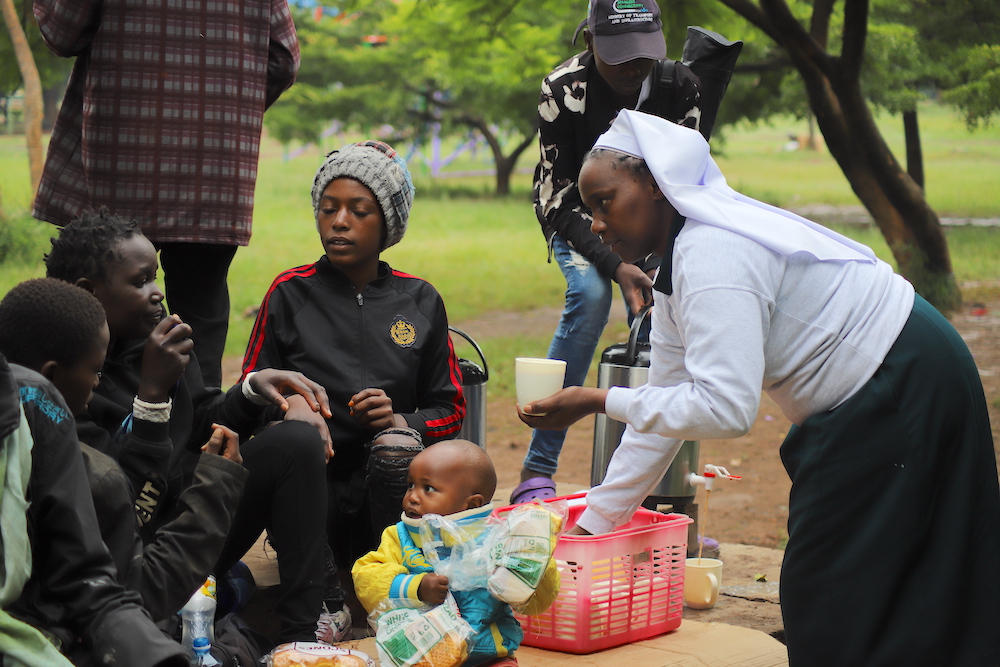 Sr. Caroline Ngatia of the Assumption of the Blessed Virgin Mary Sisters of Eldoret shares breakfast with the street families in Nairobi, Kenya. (Doreen Ajiambo)