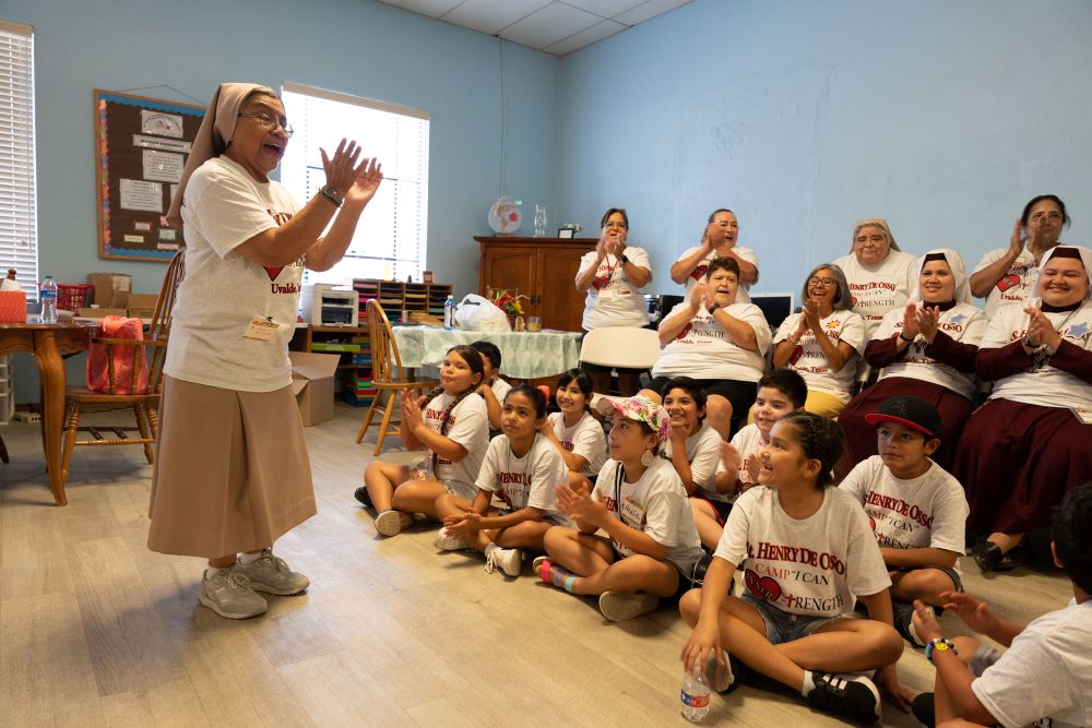 Teresian Sr. Dolores Aviles interacts with children attending Camp I-CAN, which was held July 25-28 at the St. Henry de Osso Project Center in Uvalde, Texas. (Courtesy of Catholic Extension)