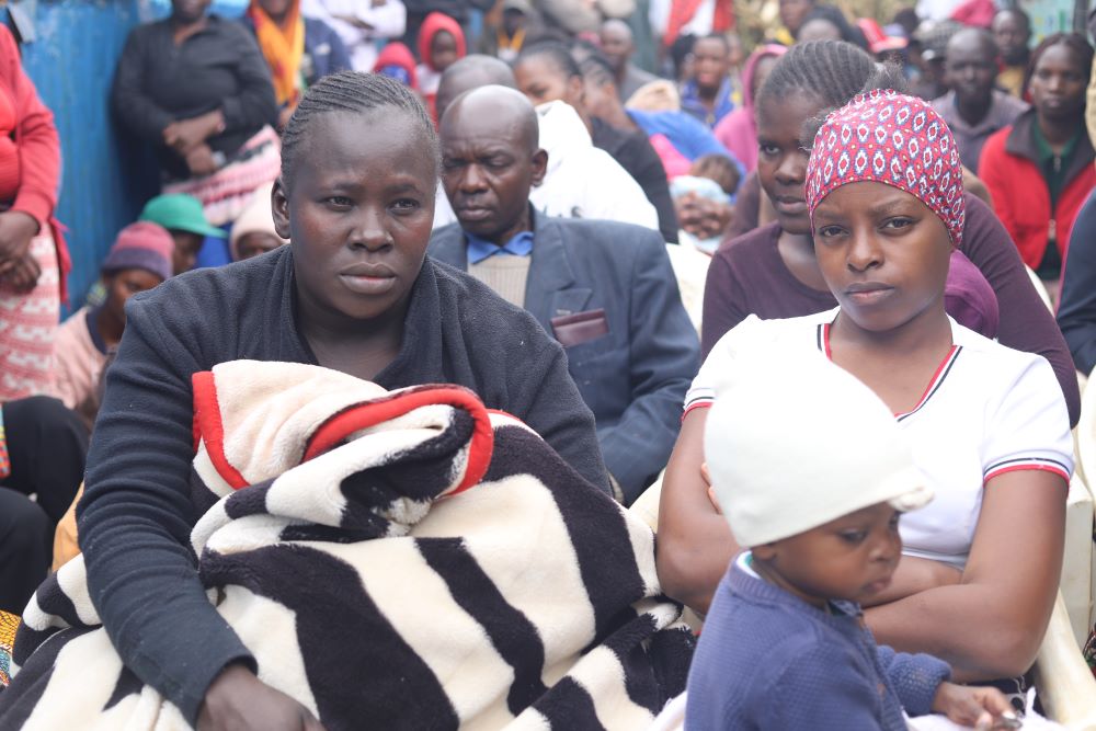 Residents of Kawangware, a low-income residential area in Nairobi, Kenya, listen to sisters during a July 22 voter education and peace campaign session. Religious sisters are carrying out civic education on voting and elections. 