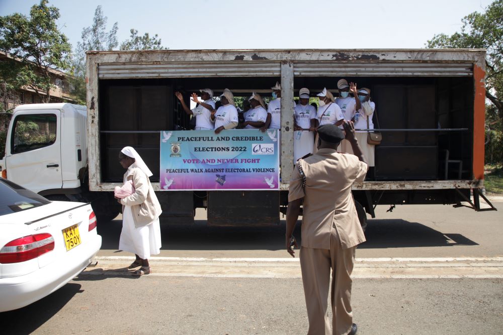 William Lang'at, the assistant county commissioner of Kisumu Central, waves at the peace caravan July 16 at St. Joseph Catholic Church in Milimani, Kisumu, Kenya. (Vincent Aduda)