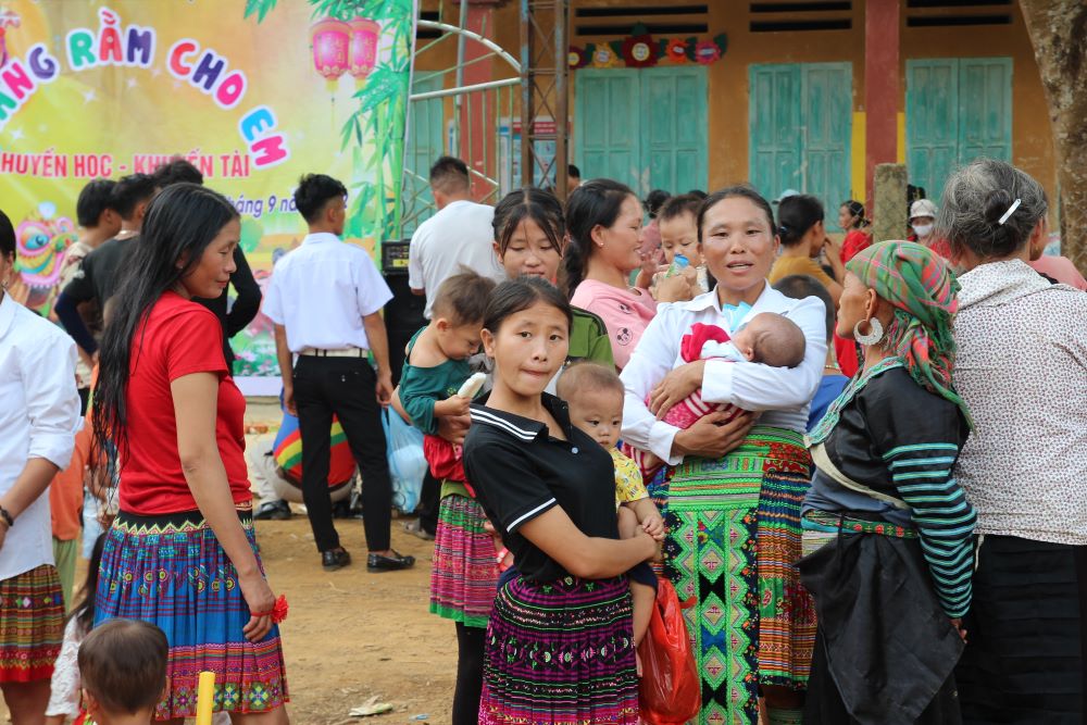Hmong ethnic women carry their babies to receive Mid-Autumn Festival gifts from the Missionaries of Charity nuns and volunteers at Pin Pe Subparish Sept. 3. (GSR photo/Joachim Pham)