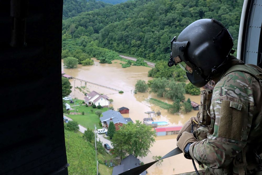 A Kentucky National Guard flight crew from 2/147th Bravo Co. flies over a flooded area in response to a declared state of emergency in eastern Kentucky July 29, 2022. (CNS/Reuters/Sgt. Jesse Elbouab, U.S. Army National Guard)