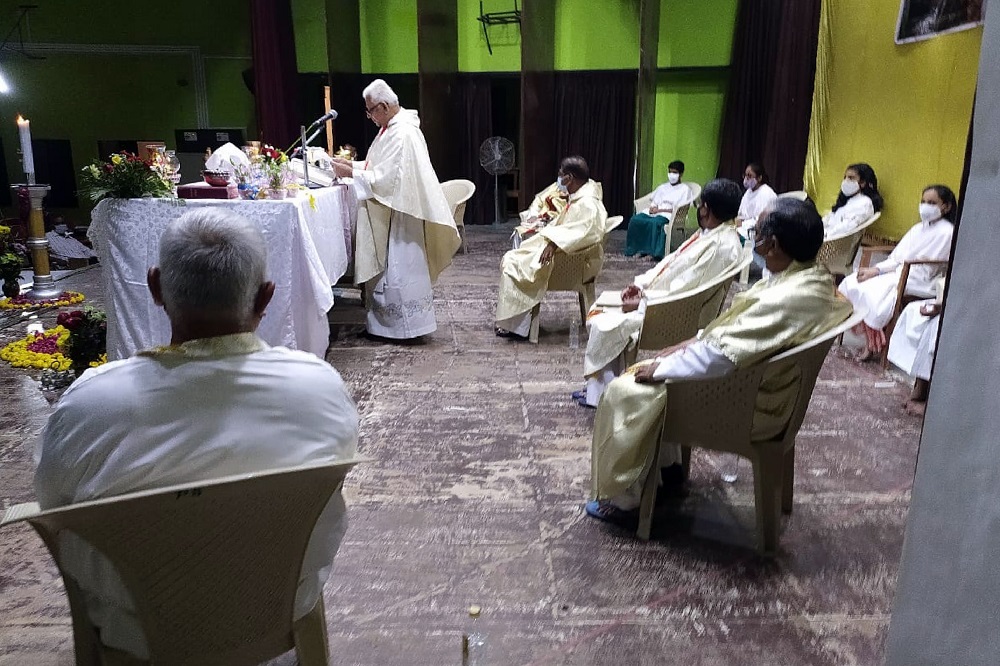 Fr. Jerry Sequeira, standing, preaches at St. Ignatius Loyola church in Ahmedabad, India, shortly before contracting and dying from the coronavirus in April 2021.