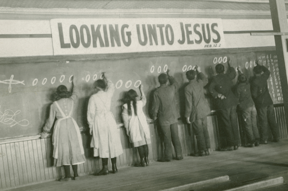 In this 1910s photo, students write on a chalkboard at the Red Deer Indian Industrial School in Alberta. (AP/United Church of Canada Archives)