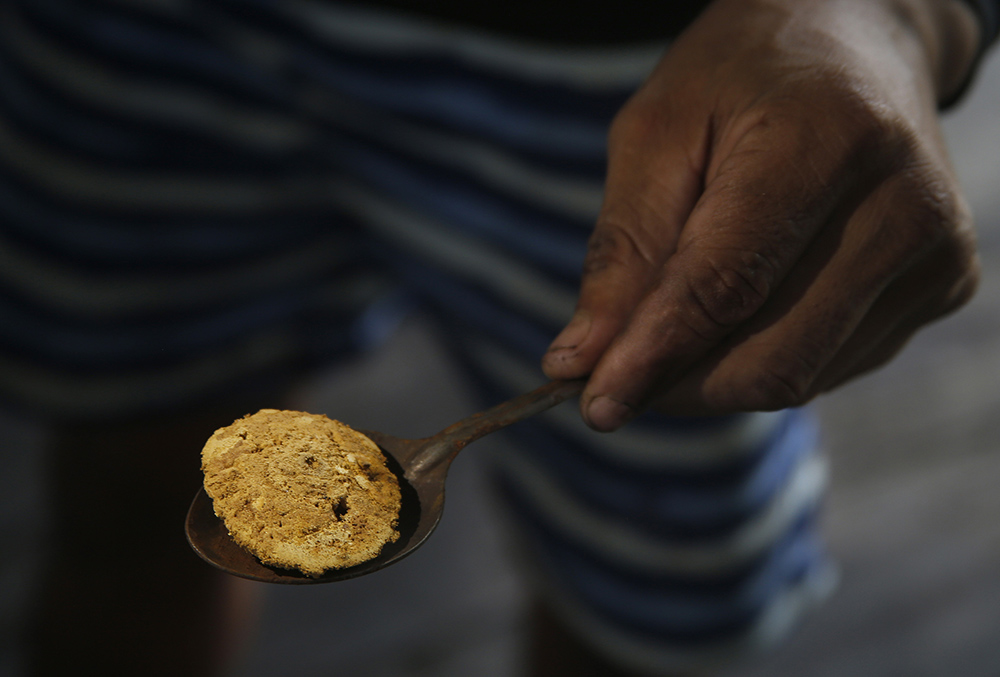 An illegal miner shows gold extracted from the Madeira River, in Nova Olinda, Amazonas state, Brazil, on Nov. 26. (AP/Edmar Barros)