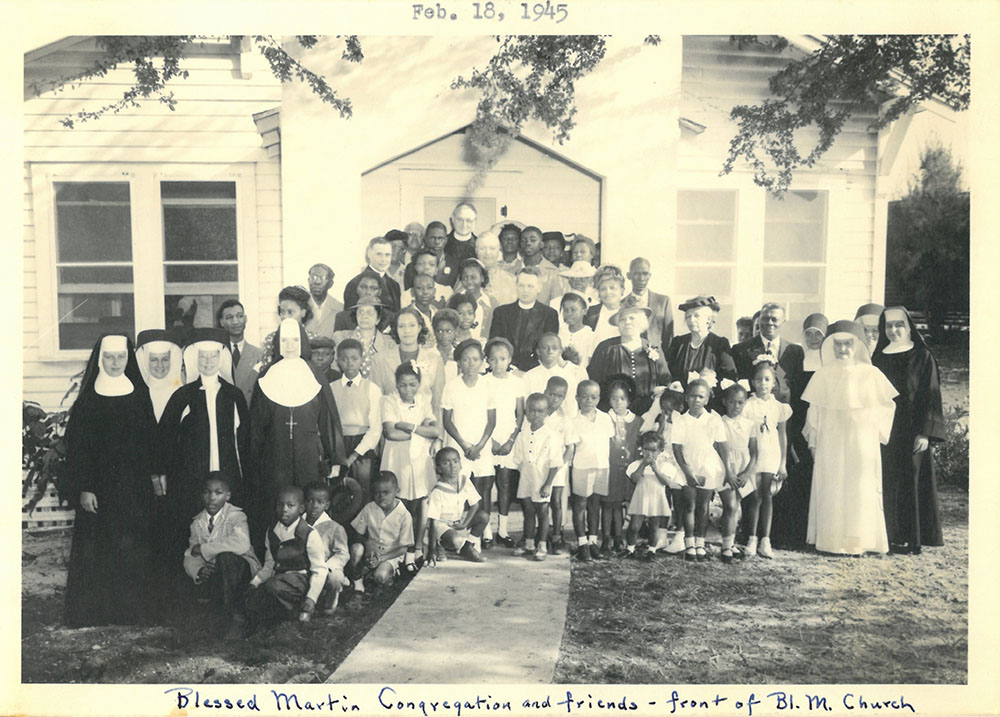 Adrian Dominican Sisters pose with parishioners and priests of the Blessed Martin de Porres Mission in Fort Pierce, Florida, for a portrait in 1945.