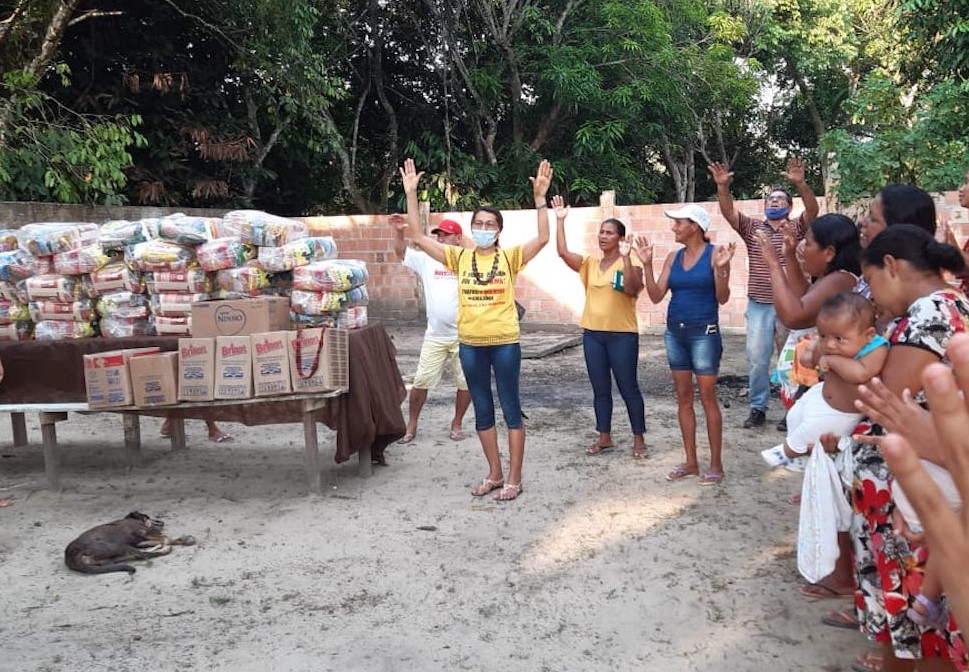 Sr. Maria Odete Pereira, center, of the Congregation of the Immaculate Heart of Mary gives thanks before the distribution of food baskets to residents of the Our Lady of Fatima community just outside of Manaus, Amazonas state, Brazil. (Courtesy of Sr. Ros