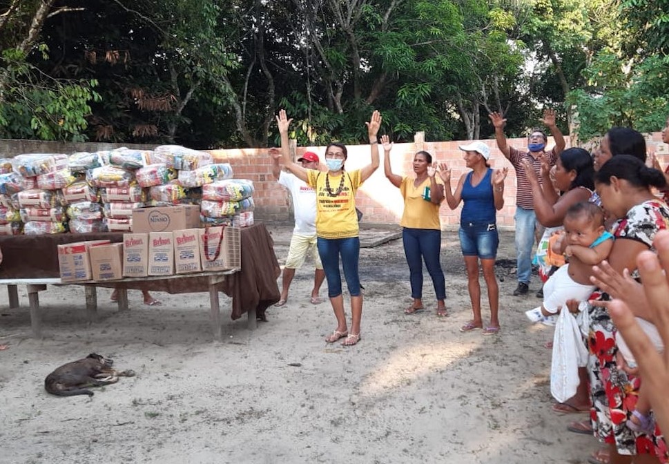 Sr. Maria Odete Pereira, center, of the Congregation of the Immaculate Heart of Mary gives thanks before the distribution of food baskets to residents of the Our Lady of Fatima community just outside of Manaus, Amazonas state, Brazil. (Courtesy of Sr. Ros Sr. Maria Odete Pereira, center, of the Congregation of the Immaculate Heart of Mary gives thanks before the distribution of food baskets to residents of the Our Lady of Fatima community just outside of Manaus, Amazonas state, Brazil. (Courtesy of Sr. Ros