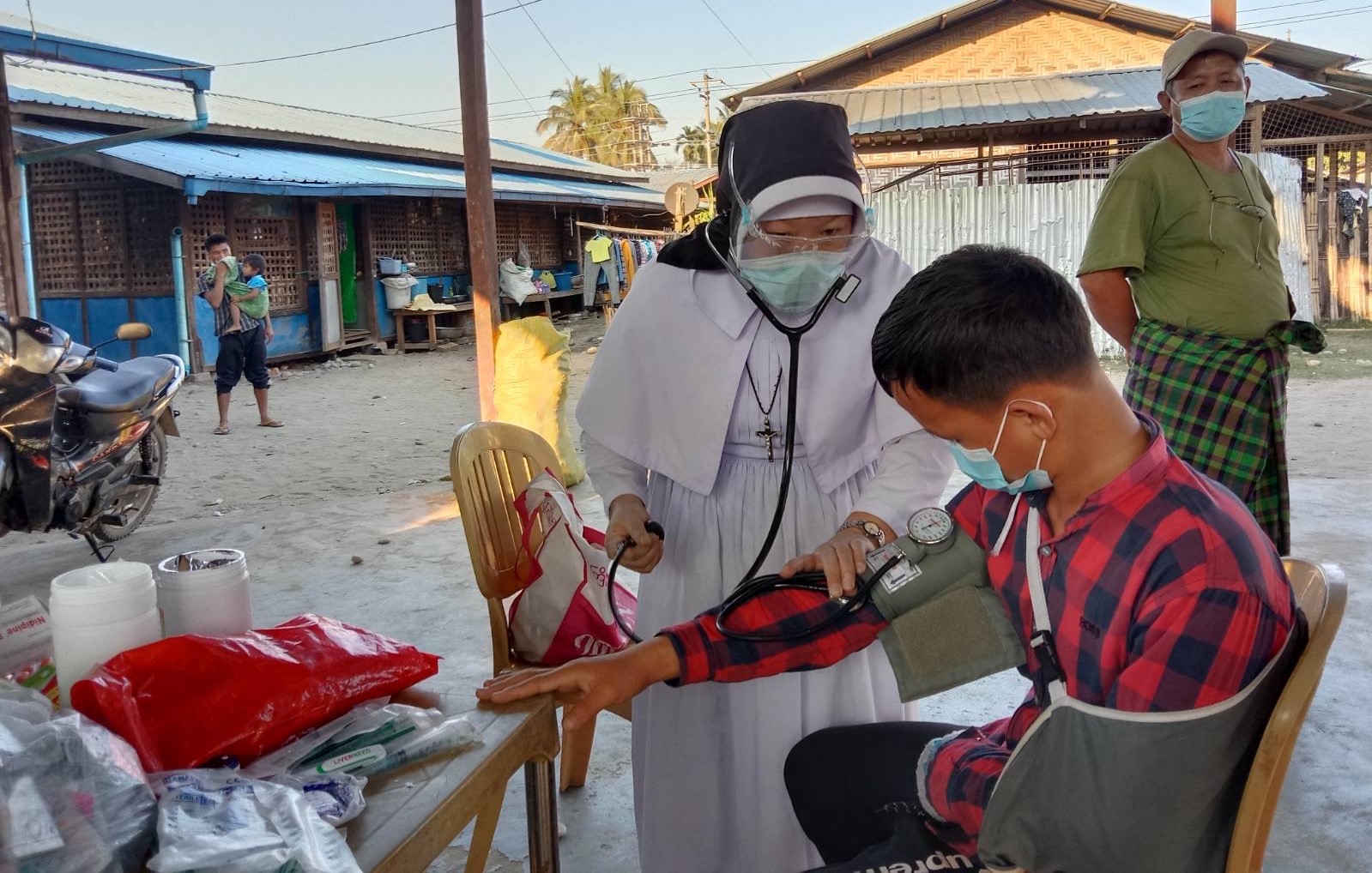 Sr. Ann Rose Nu Tawng checks the blood pressure of a man at a camp for internally displaced people near Myitkyina, the capital city of Kachin state, on Feb.19.