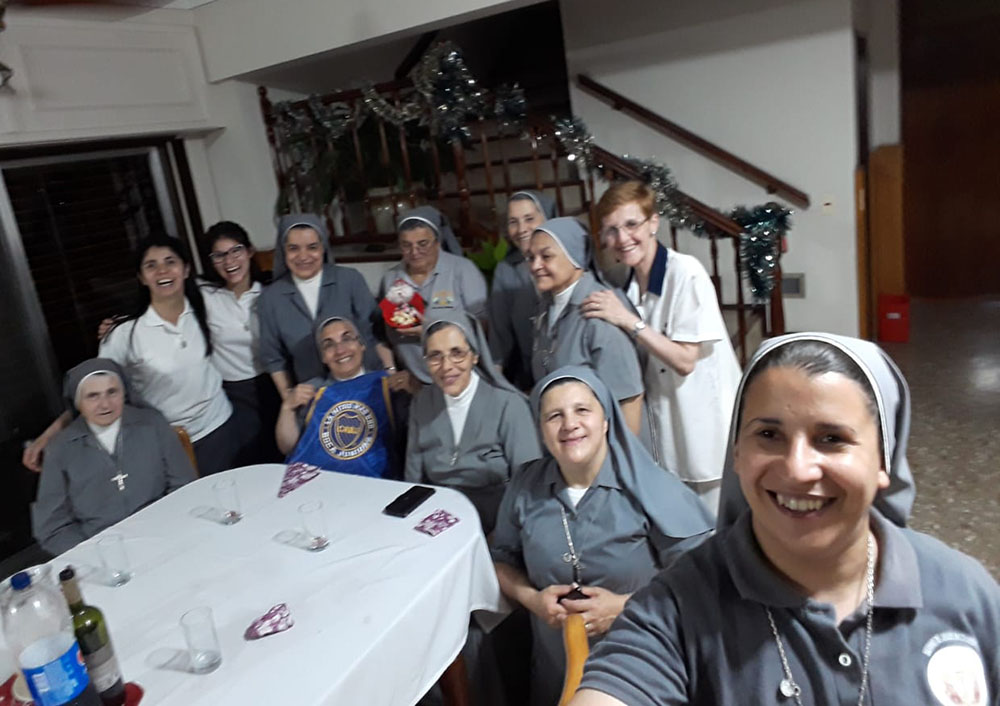 Servant of Sacred Jesus Sr. Evangelina Herrera, taking the selfie, celebrates a previous Christmas with her community, a tradition that they'll be able to maintain this year despite the pandemic's disruptions. (Provided photo)