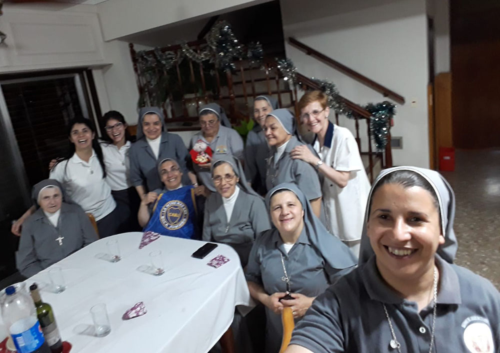 Servant of Sacred Jesus Sr. Evangelina Herrera, taking the selfie, celebrates a previous Christmas with her community, a tradition that they'll be able to maintain this year despite the pandemic's disruptions. (Provided photo) Servant of Sacred Jesus Sr. Evangelina Herrera, taking the selfie, celebrates a previous Christmas with her community, a tradition that they'll be able to maintain this year despite the pandemic's disruptions. (Provided photo)