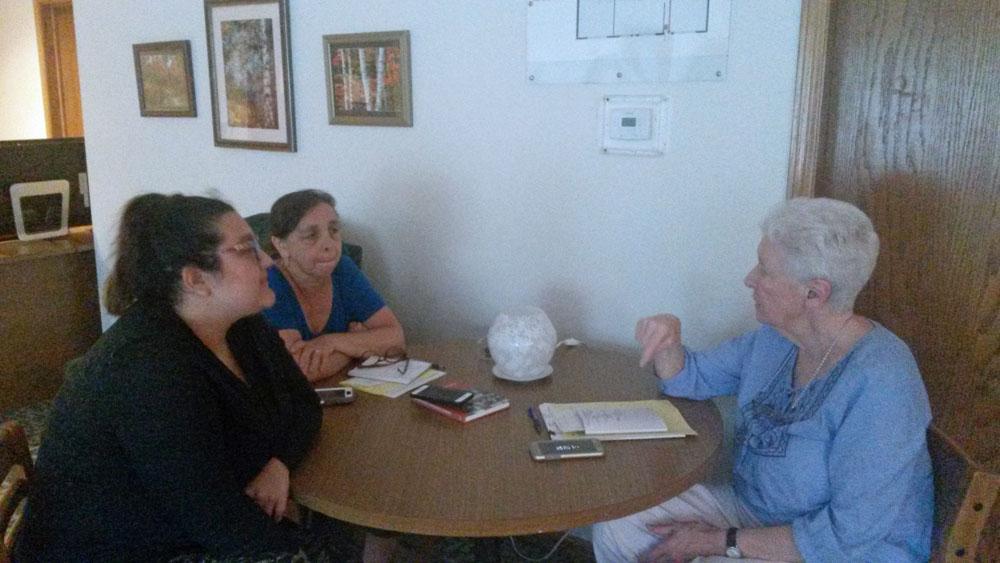 Bethany House of Hospitality staff meet June 19, 2018, at Bethany House in Bartlett, Illinois; from left: Jessica Alaniz, staff case manager, Darlene Gramigna, executive director, and Benedictine Sr. Patricia Crowley, founder. 