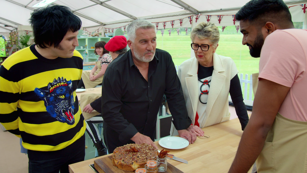 Judges from "The Great British Baking Show" talk to a contestant