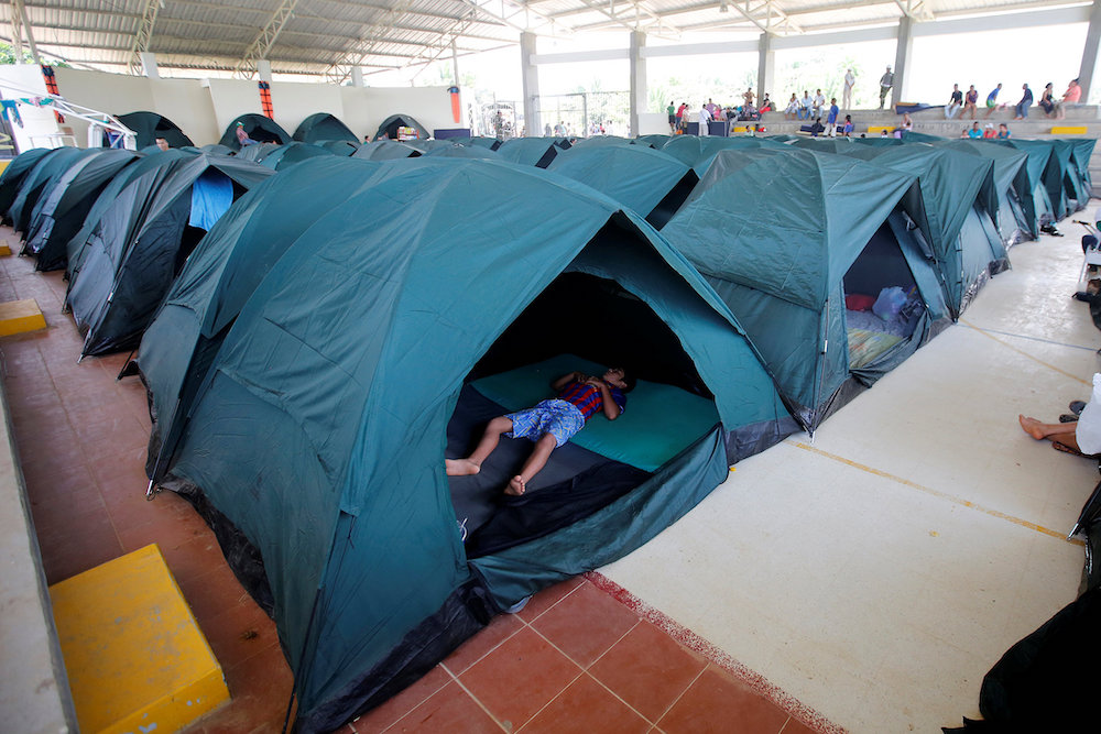 A child sleeps in a tent April 4, 2017, at a shelter for people left homeless after mudslides in Mocoa, Colombia. (CNS/Reuters/Jaime Saldarriaga)