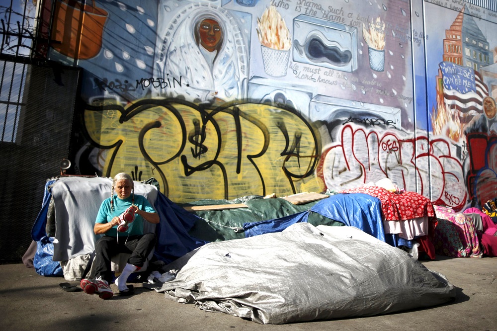 A woman sits outside her tent on Skid Row in downtown Los Angeles in 2015. (CNS/Reuters/Lucy Nicholson)