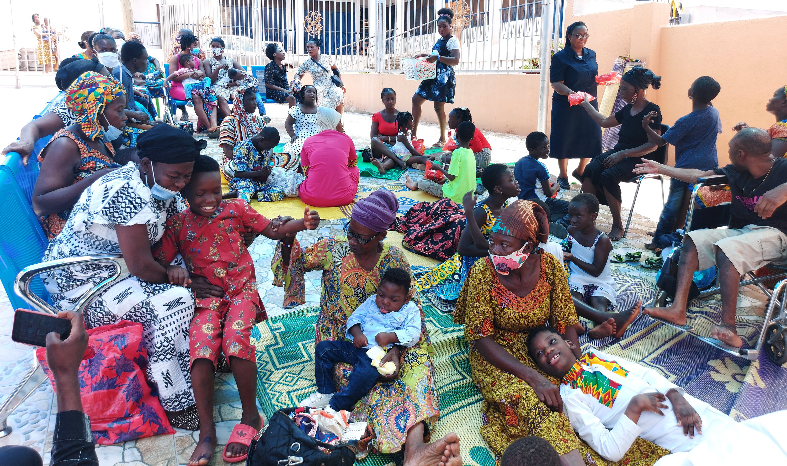 Sr. Olivia Umoh, a member of the Daughters of Charity of St. Vincent de Paul, speaks with parents and children with disabilities Oct. 13 in a Catholic-run facility courtyard next to St. Peter Cathedral in Kumasi, Ghana. (CNS/Courtesy of SCP)