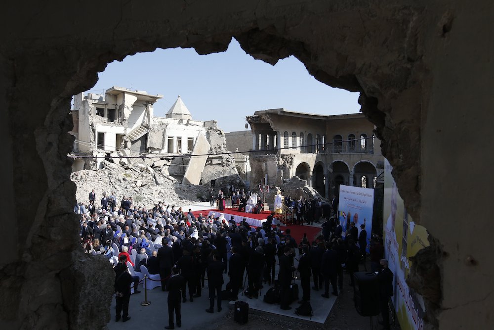 People gathered in bombed out church square with Pope Francis in Mosul, Iraq