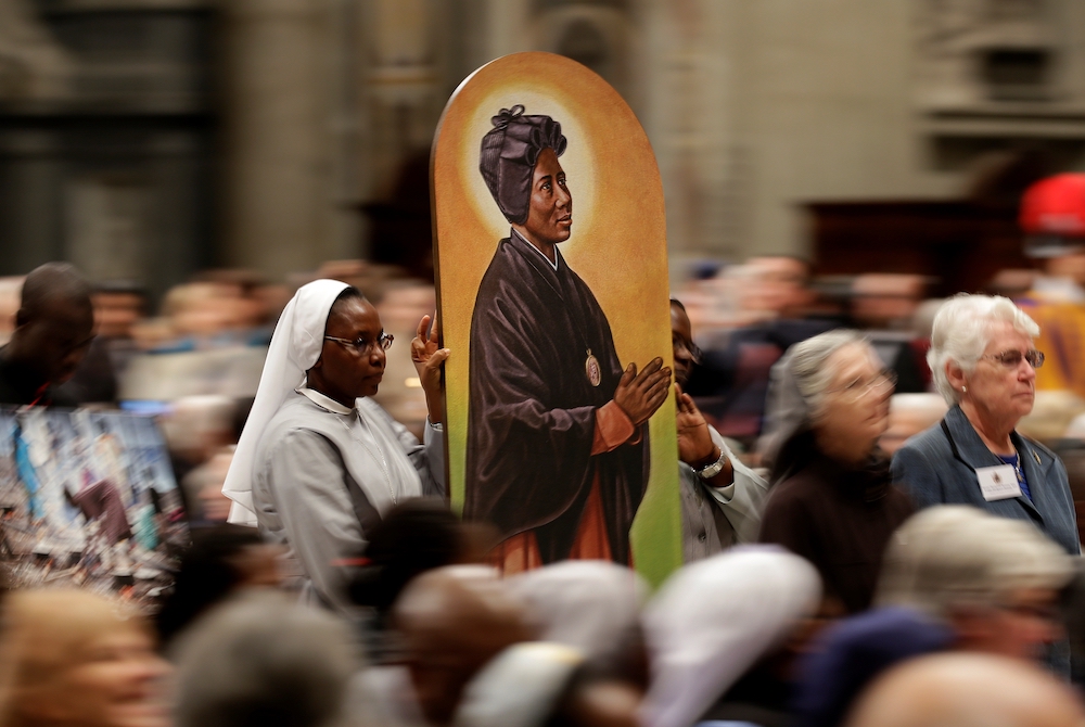 An image of Sudanese St. Josephine Margaret Bakhita, a Canossian Daughter of Charity, is carried in procession during a prayer service in 2017. (CNS/Reuters/Max Rossi)