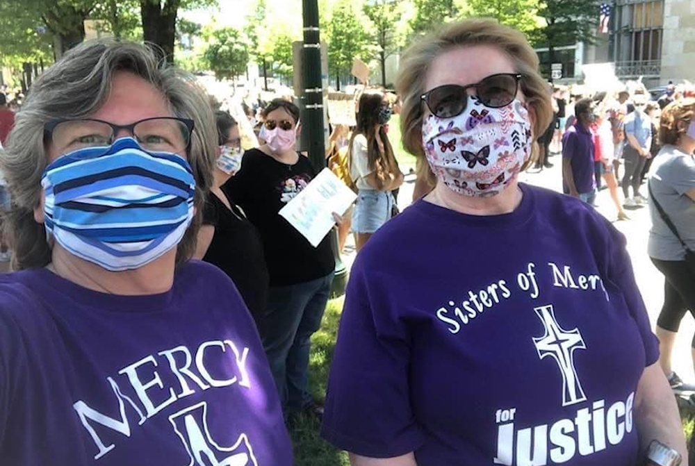 Mercy Srs. Lisa Griffith and Regina Ward, leaders in the Mercy Education System of the Americas, take part in a peaceful protest June 7 in Silver Spring, Maryland. (CNS/Courtesy of the Mercy Sisters of the Americas)