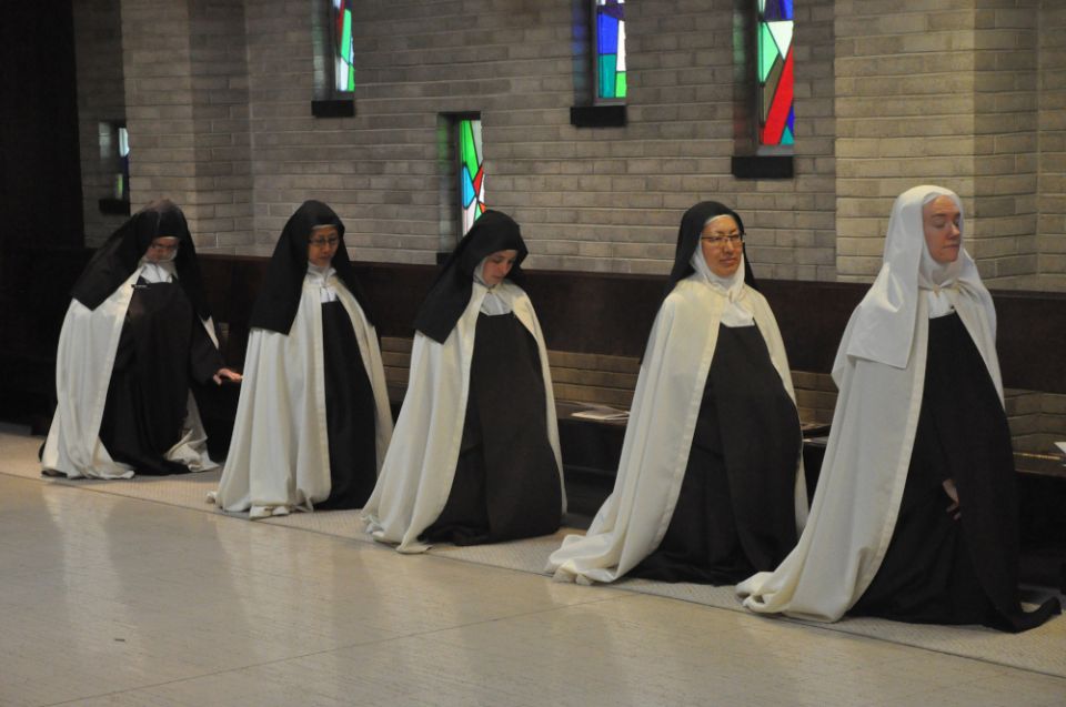 Discalced Carmelite Sisters Mary Grace Melchior, Marianna So, Marie Cecile Franer, Susanna Choi and Christine Rosencrans kneel at the Carmelite Monastery of St. Joseph in Terre Haute, Indiana.