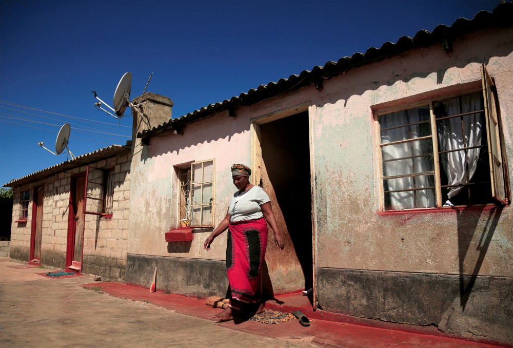 A woman walks out of her family home in Harare, Zimbabwe, on May 9 during the COVID-19 pandemic. (CNS/Reuters/Philimon Bulawayo) 