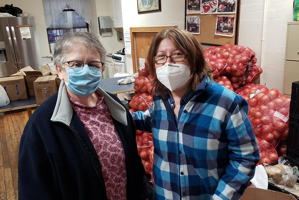 Sr. Antonina Avitabile of the Missionary Sisters of the Sacred Heart of Jesus, left, and Margarita Tlaseca Vides regularly volunteer at the food pantry at Cabrini Immigrant Services. (GSR photo/Chris Herlinger) 