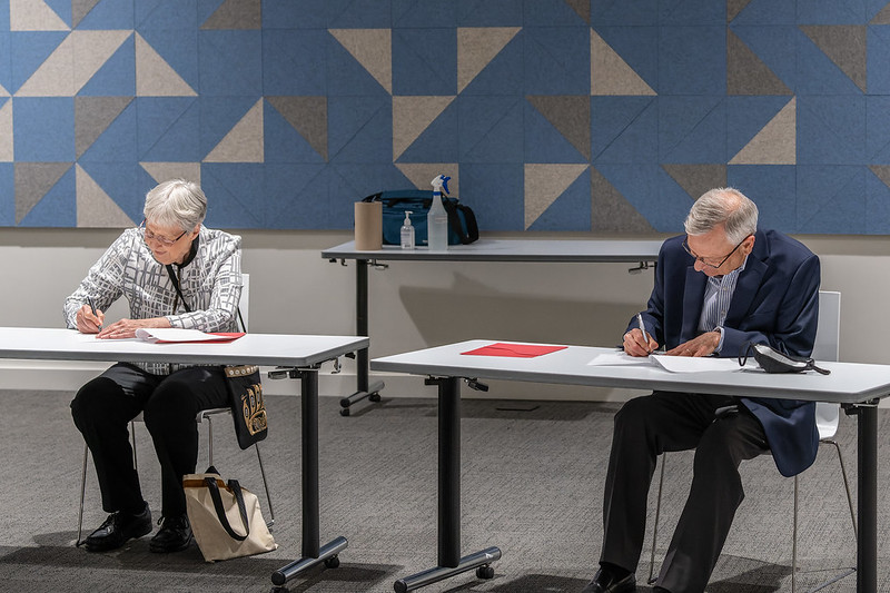 Sr. Marie Zarowny, left, president of the Sisters of St. Ann, signs a joint agreement to share archived materials from the First Nation residential school in Kamloop, British Columbia, with the Royal British Columbia Museum. Signing for the museum is Dan 