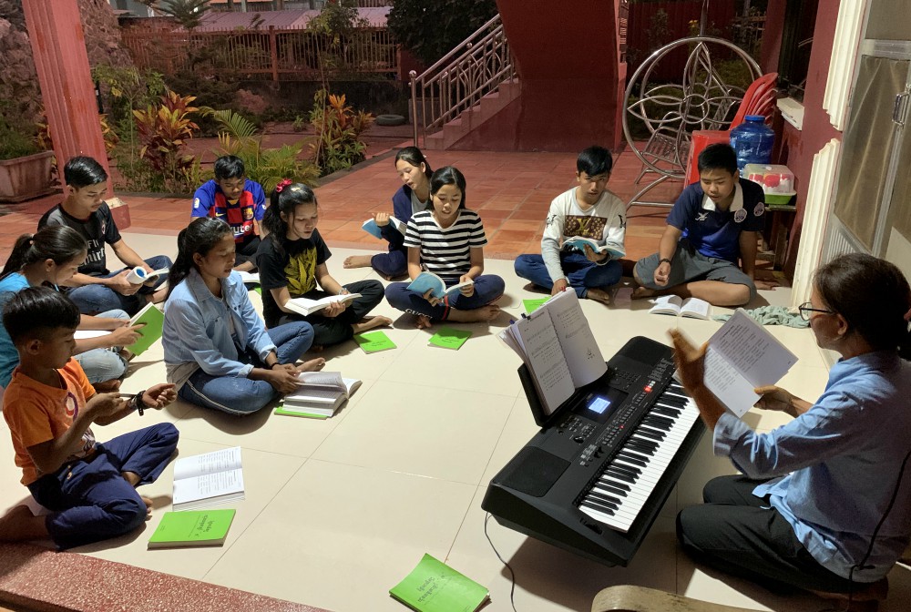 Lovers of the Holy Cross Sr. Hill Pen leads choir practice on a Saturday evening at the Catholic church in Stung Treng, Cambodia, earlier this year. (Akarath Soukhaphon)