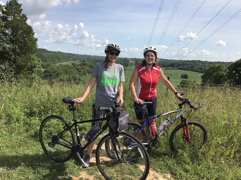 Sr. Chris Kunze, left, and Sr. Lisa Polega, both Sisters of Charity of Nazareth, pause while riding the Parklands of Floyds Fork in Kentucky. (Courtesy of Cycling With Sisters)
