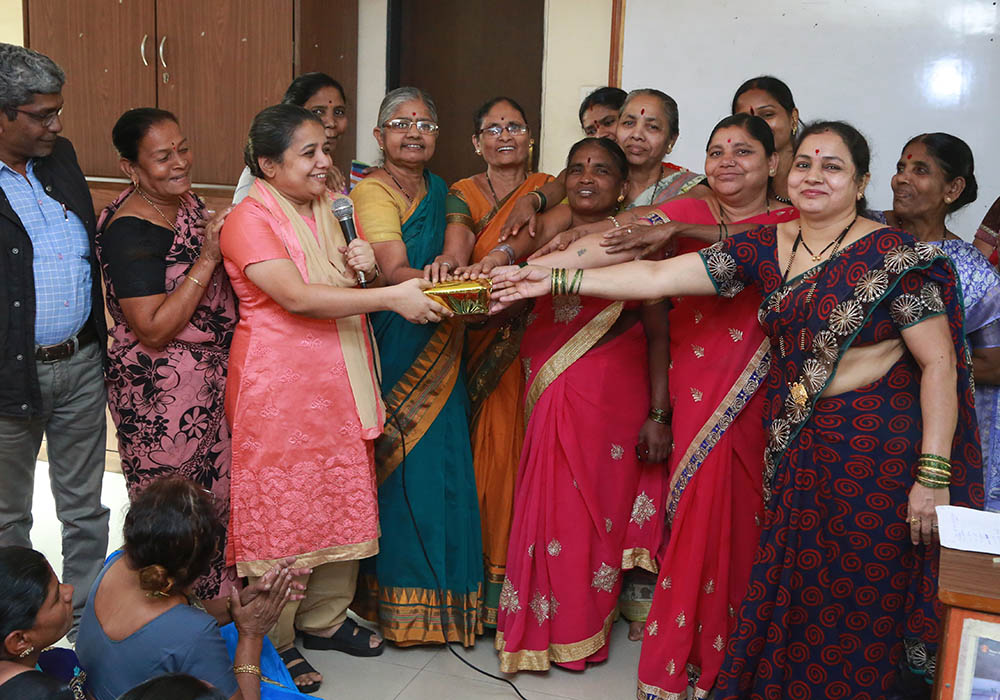 Sr. Christin Mary (in pink, holding microphone), a member of the Missionary Sisters of the Immaculate Heart of Mary and a coordinator of the National Domestic Workers' Movement, with a group of domestic workers in February 2019 in the western Indian city 