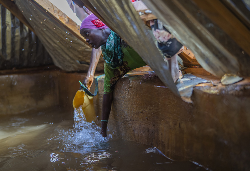 A Somali woman fills a container with water Sept. 20 at a camp for displaced people on the outskirts of Dollow, Somalia. (AP photo/Jerome Delay) A Somali woman fills a container with water Sept. 20 at a camp for displaced people on the outskirts of Dollow, Somalia. (AP photo/Jerome Delay)