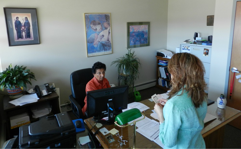 Chicago Benedictine Sr. Karen Bland, left, in her office at Grand Valley Catholic Outreach in Grand Junction, Colorado, where she is executive director (Courtesy of the Benedictine Sisters of Chicago)