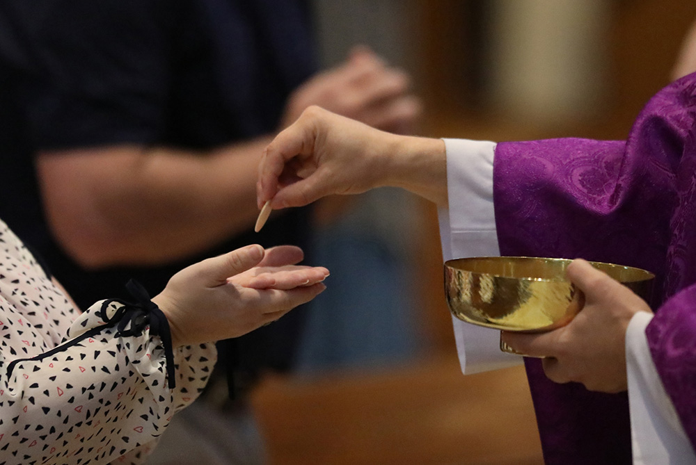 Although there are advantages to online Masses, such as availability of worship at any time, plus the choice of a homilist, there is the "hole" at Communion time. (CNS/The Register/Karen Bonar)