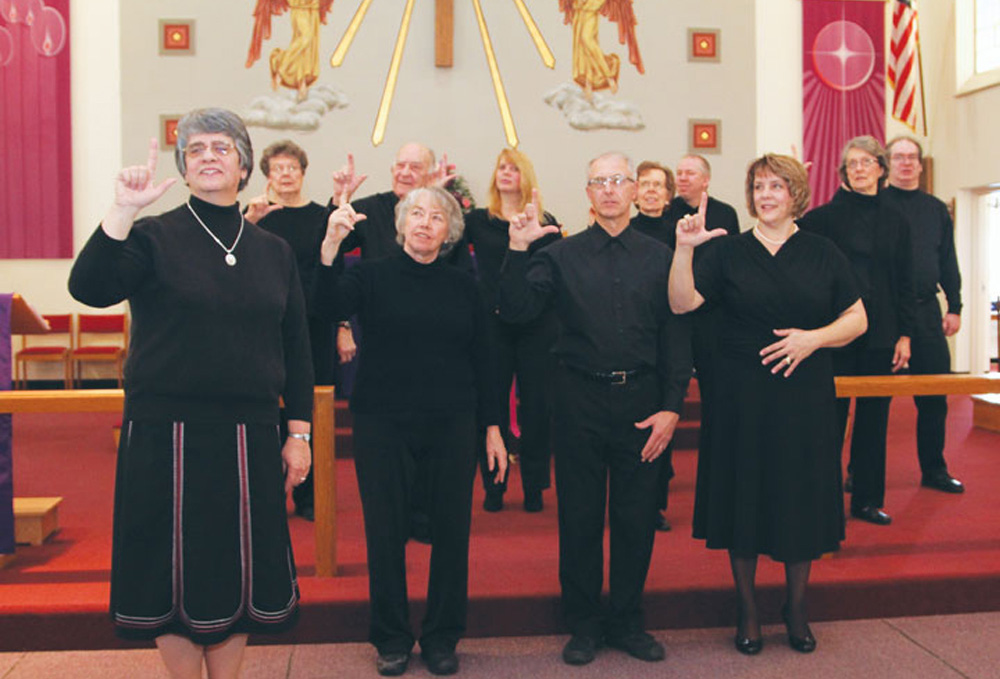 Sr. Conchetta LoPresti, left, signs "Lord" with the sign choir during a 2013 Mass at Resurrection Parish in Cheektowaga, New York. (Courtesy of Sisters of St. Francis of the Neumann Communities) Sr. Conchetta LoPresti, left, signs "Lord" with the sign choir during a 2013 Mass at Resurrection Parish in Cheektowaga, New York. (Courtesy of Sisters of St. Francis of the Neumann Communities)