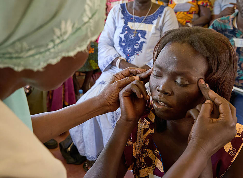 Constance Langoya, a trauma healer, helps Joyce Charles during a trauma-healing workshop at the Rejaf School for the Blind in Juba, South Sudan. (Courtesy of Solidarity with South Sudan/Paul Jeffrey)