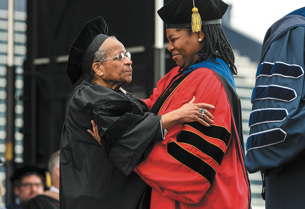 Shannen Dee Williams, right, presents Mercy Sr. Cora Marie Billings with an honorary doctorate at Villanova University's May 2019 commencement ceremony. (Courtesy of Villanova University)