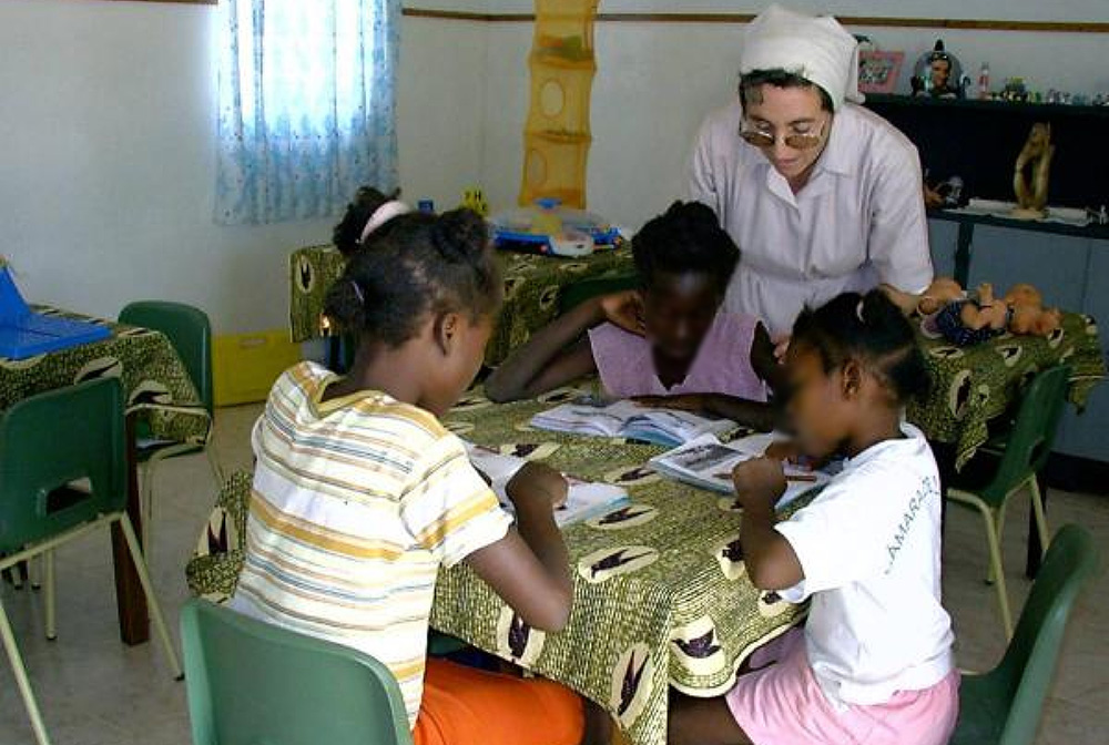 A Sister of St. Vincent de Paul of Lendelede with children at the St. Vincent de Paul Children Rehabilitation Center for daily care. This photo has been edited to protect the children's identities. (Aimable Twahirwa) A Sister of St. Vincent de Paul of Lendelede with children at the St. Vincent de Paul Children Rehabilitation Center for daily care. This photo has been edited to protect the children's identities. (Aimable Twahirwa)