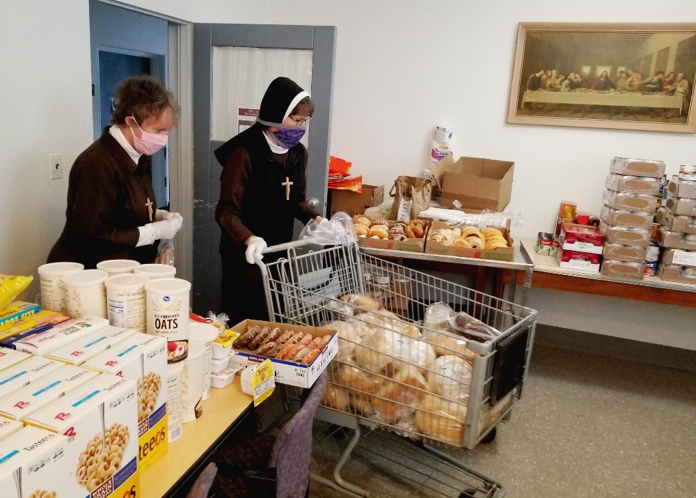 Deo Gratias Ministries Detroit co-directors Sr. Shelley Marie Jeffrey, left, and Sr. Felicity Marie Madigan sort and organize supplies in the food pantry. (Courtesy of the Felician Sisters of North America) Deo Gratias Ministries Detroit co-directors Sr. Shelley Marie Jeffrey, left, and Sr. Felicity Marie Madigan sort and organize supplies in the food pantry. (Courtesy of the Felician Sisters of North America)