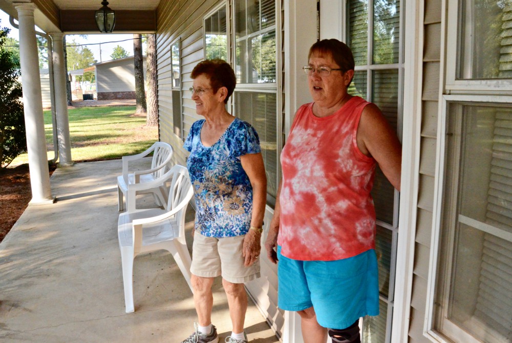 Sr. Clare Van Lent, left, and Sr. Mary Horrell look at the grounds of the retreat center run by their order, the Dwelling Place, in September 2019 in Brooksville, Mississippi. (GSR photo / Dan Stockman)