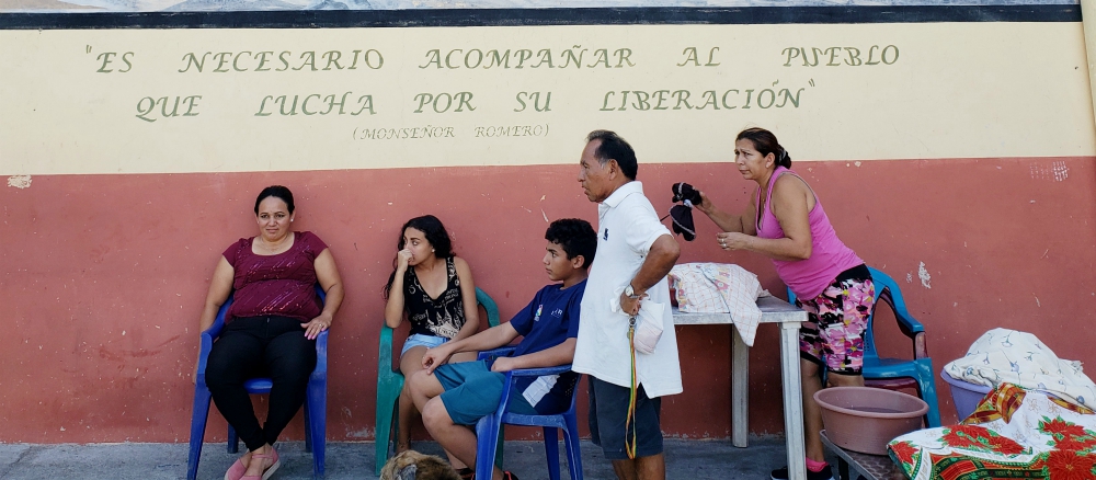 People are seen outside the home shared by three Sacred Heart sisters in La Chacra, on the outskirts of San Salvador, an economically depressed area and vulnerable to violence in El Salvador. (Chris Herlinger)