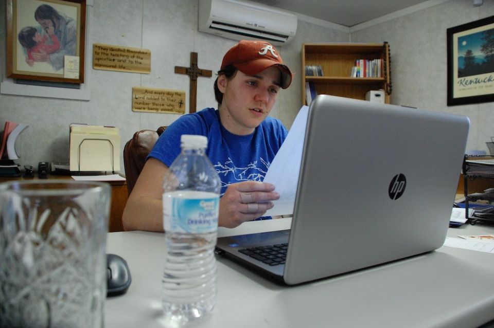 St. Vincent Mission Executive Director Erin Bottomlee looks over reports of volunteer work done to help the poor living in the area around David, Kentucky.